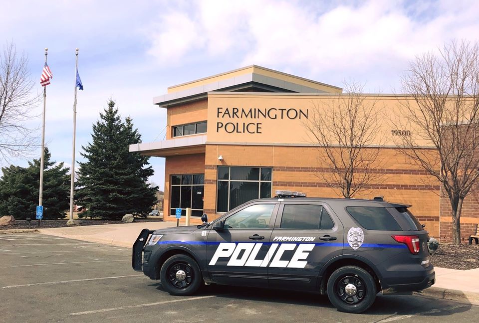 Police Department main entrance with a squad car parked in front