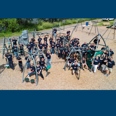 Team Farmington aerial image of Farmington employees spread out across playground equipment