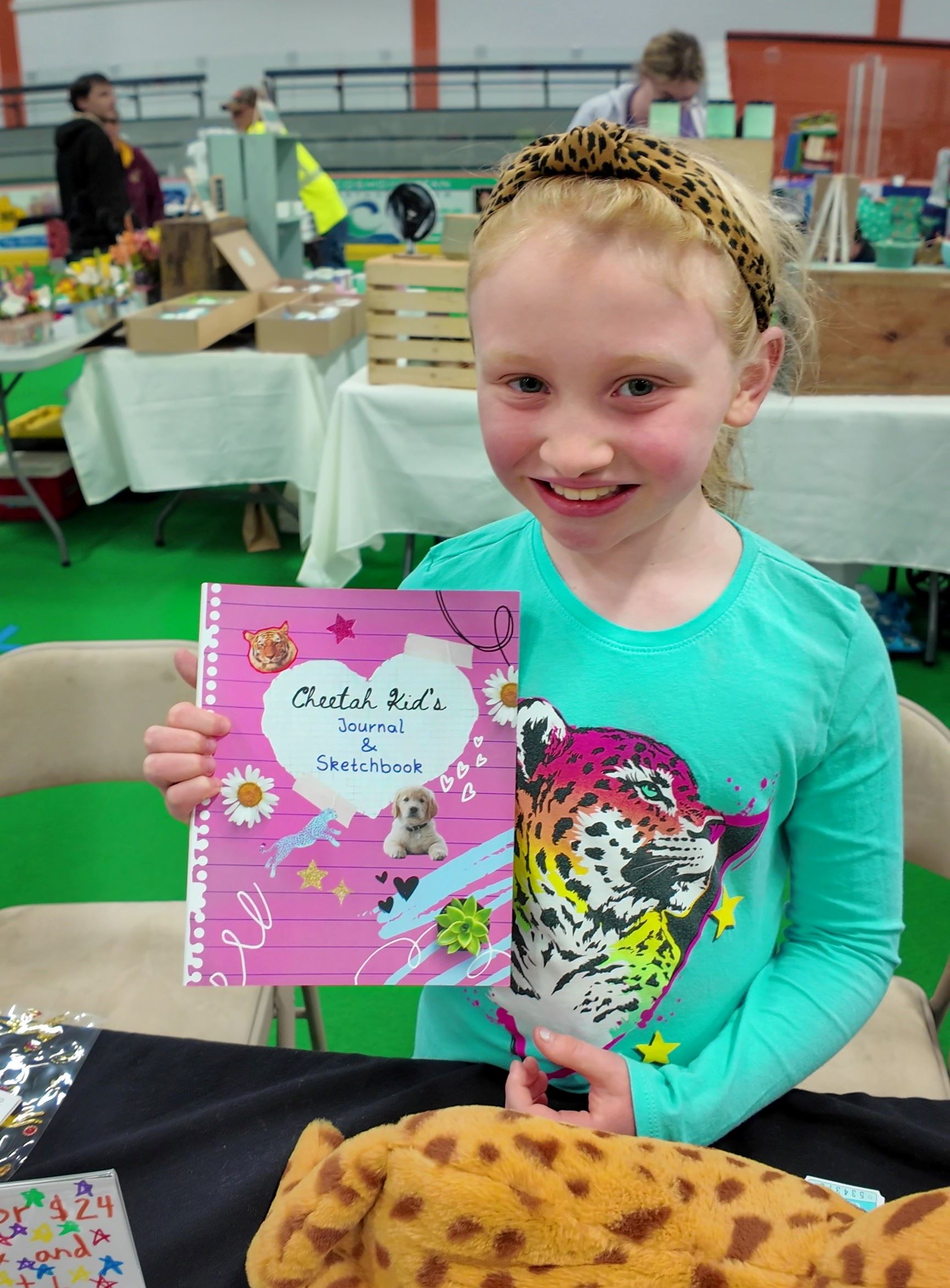 A girl holding a journal at the Arts and Craft Fair