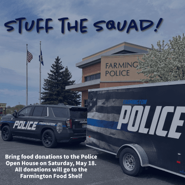 Squad car and trailer parked in front of Police Department with text Stuff the Squad!