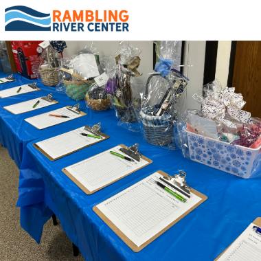Rambling River Center Silent Auction with RRC logo and image of auction baskets
