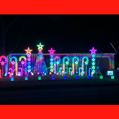 Holiday Lights Tour house with lights on house and decorations and lights all over lawn